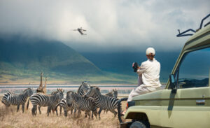 Group of travelers observing wildlife in the vast Serengeti plains during an adventure in Tanzania
